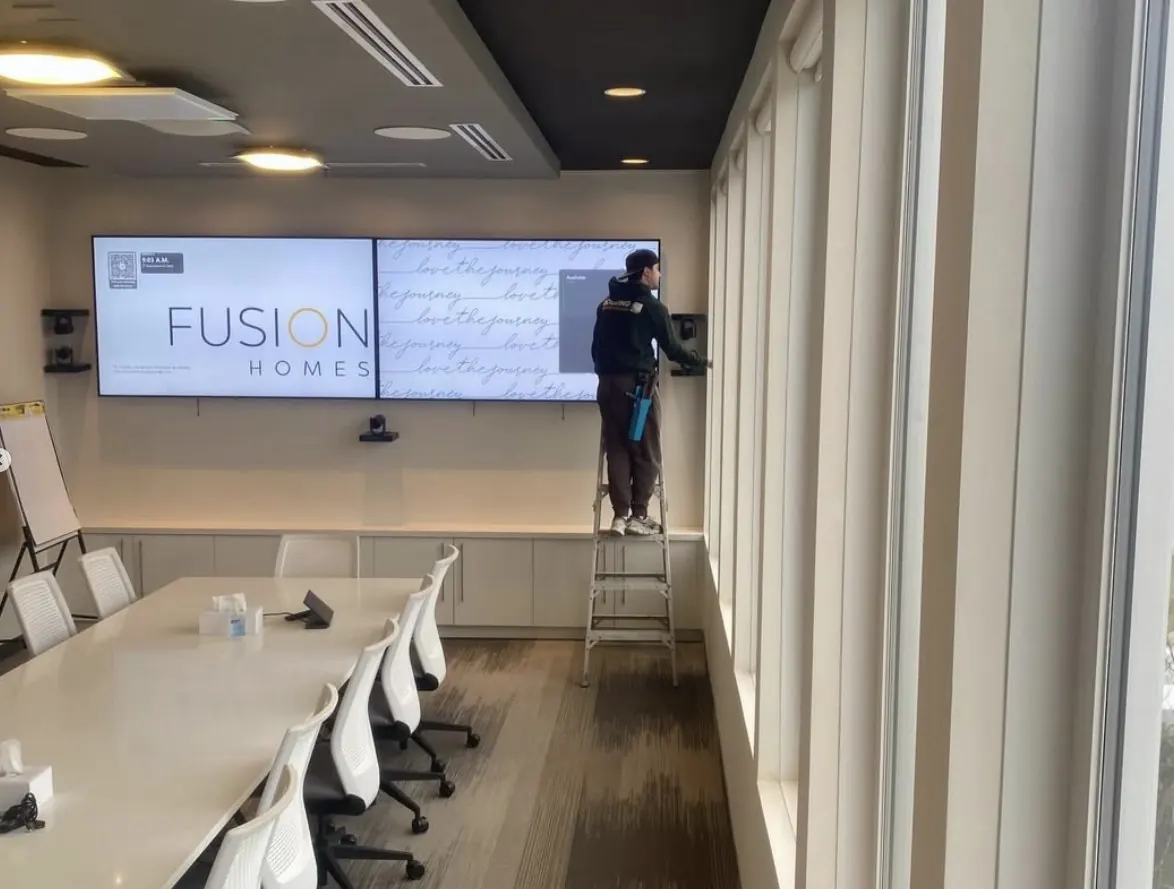 Doering Window Cleaning technician cleaning interior commercial office windows in Guelph Ontario